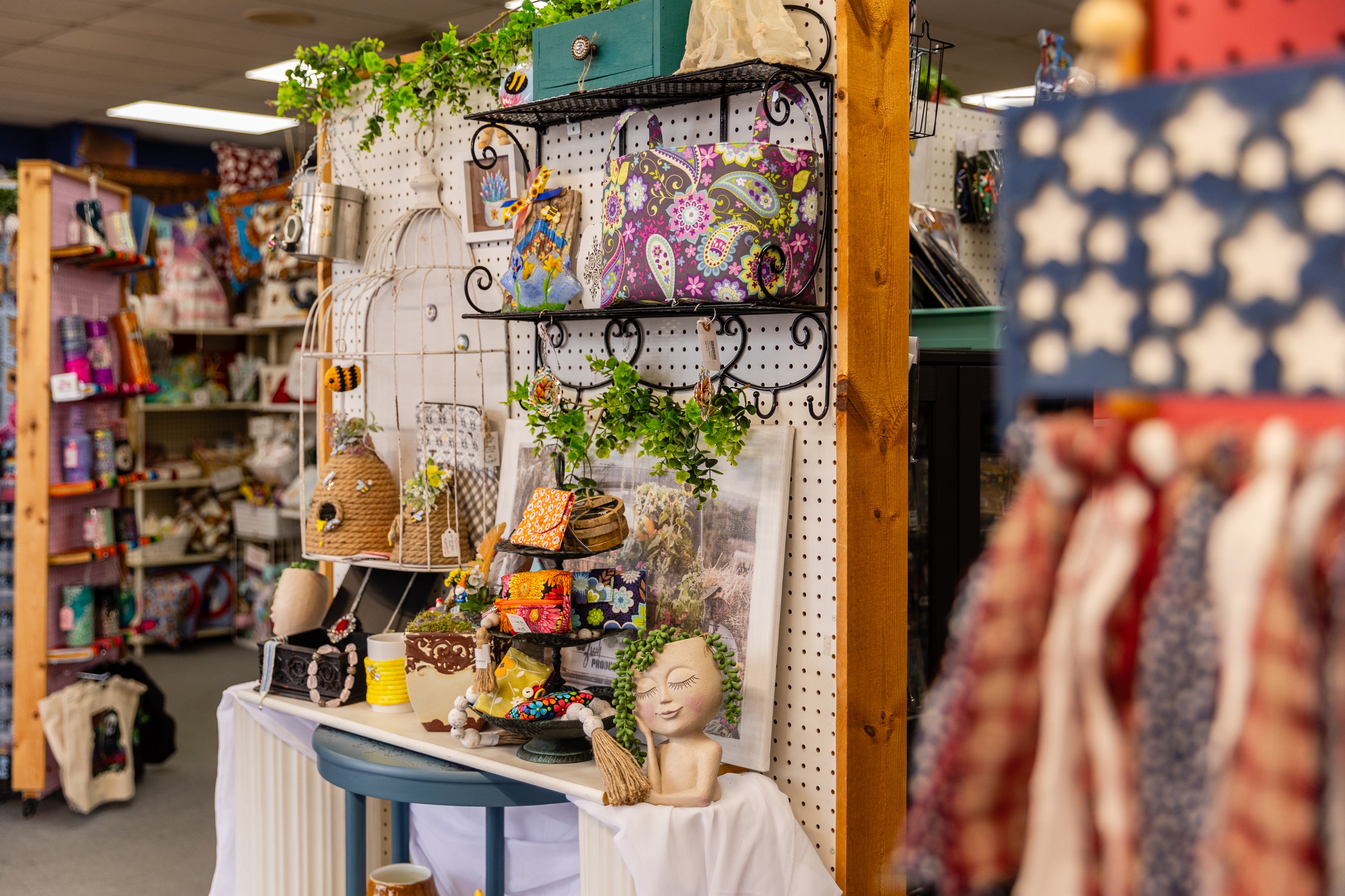 Alamo Craft Company display with various decorative items and a table with more products.
