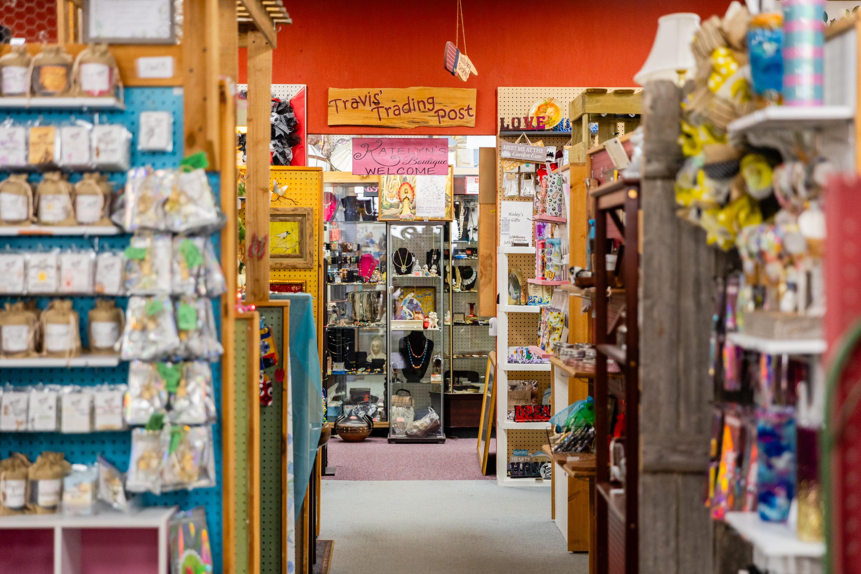 Interior of Alamo Craft Company with shelves stocked with various items and colorful decor.