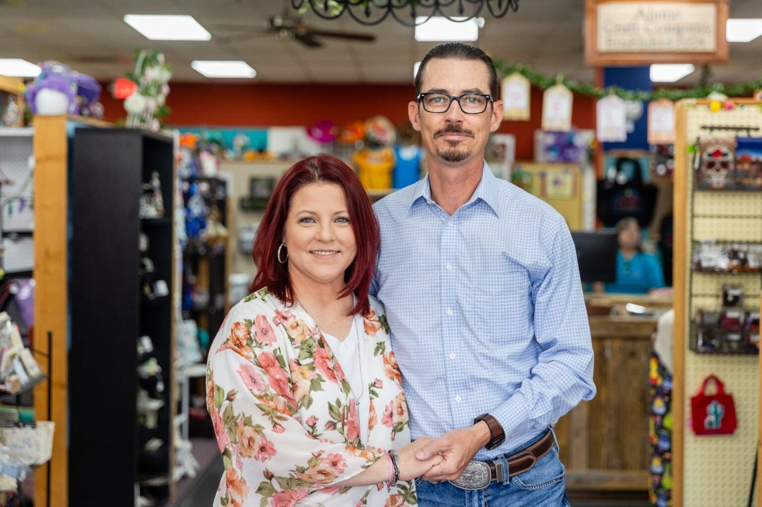 A man and woman standing in front of a store.