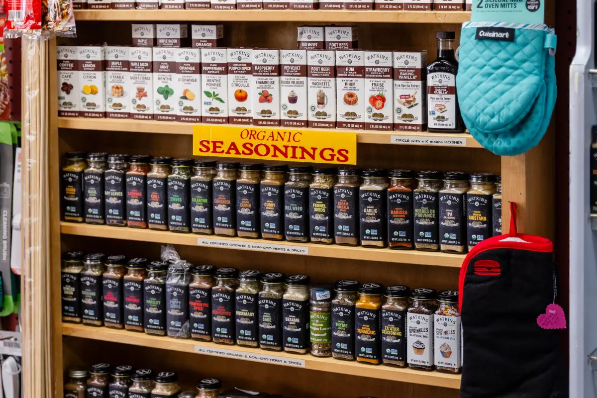 A shelf filled with lots of spices and seasonings.