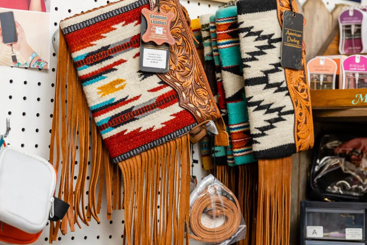 A variety of leather goods are displayed on display.