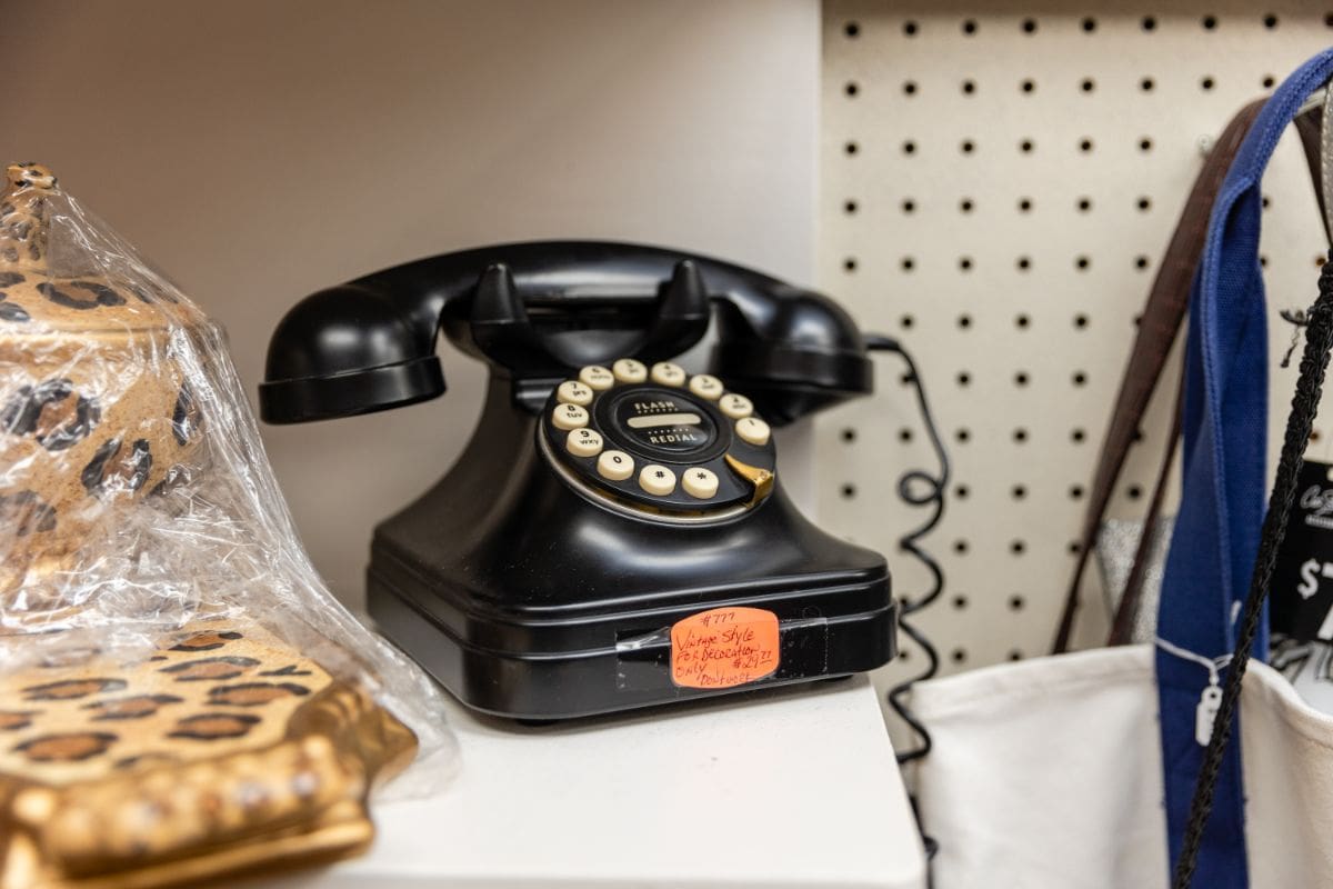 A black telephone sitting on top of a table.