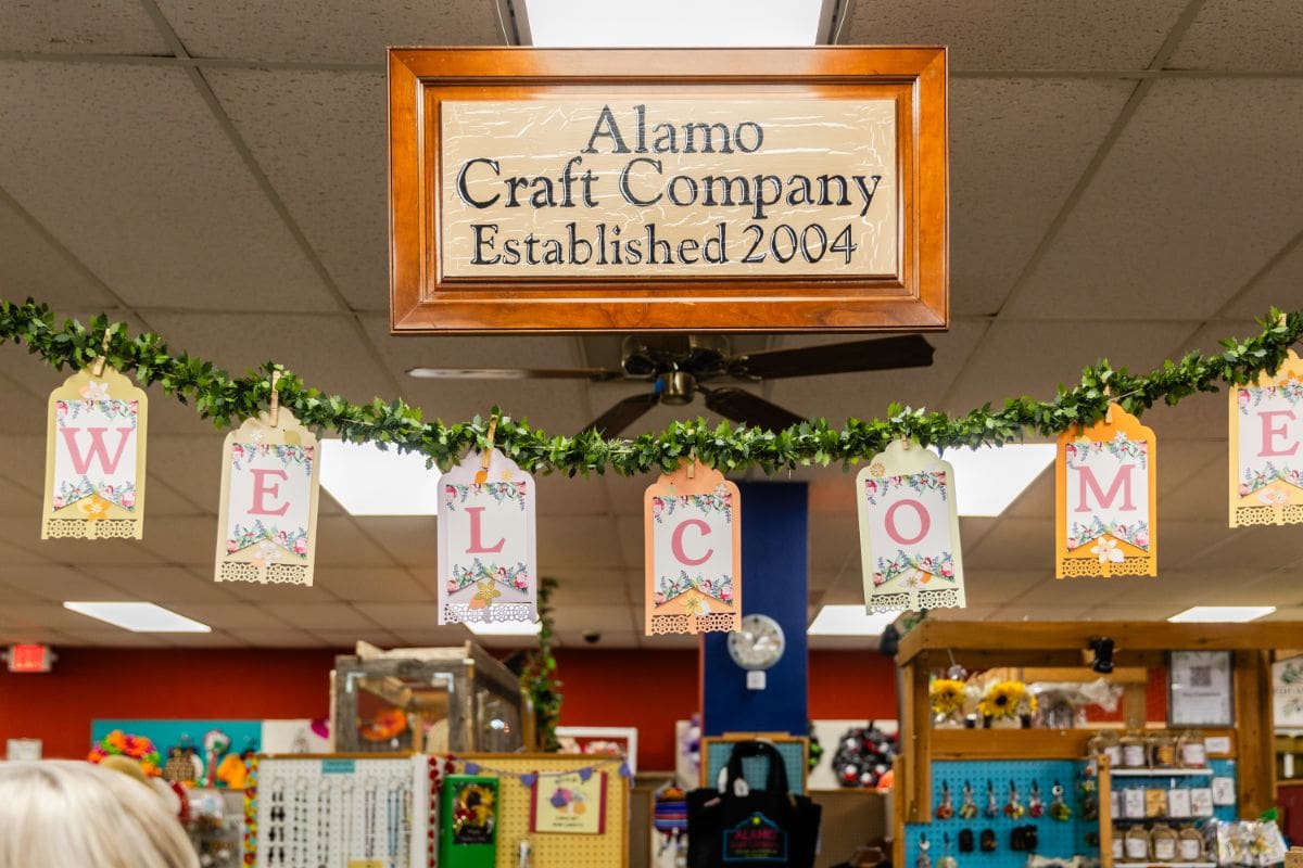 A sign hanging from the ceiling of a store.