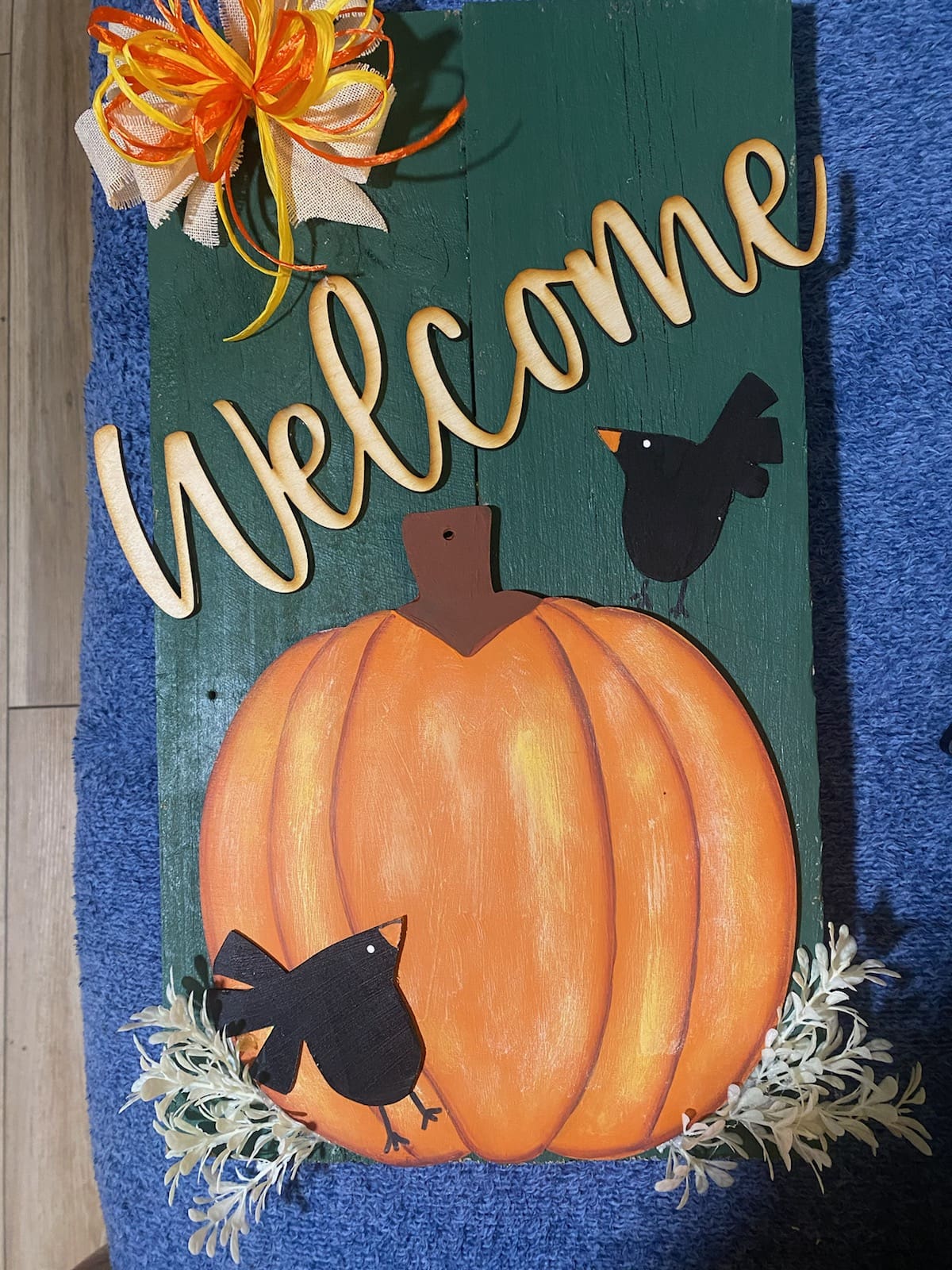 Welcome sign with pumpkin and birds.