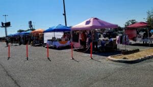 Outdoor market with several vendor tents.